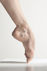 close-up-ballerina-s-legs-white-floor-2.jpg